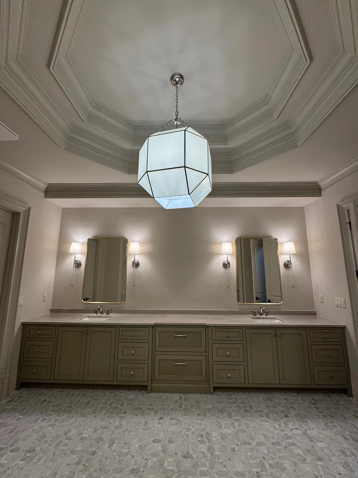 Double vanity with tray ceiling and pendant lighting in a master bathroom