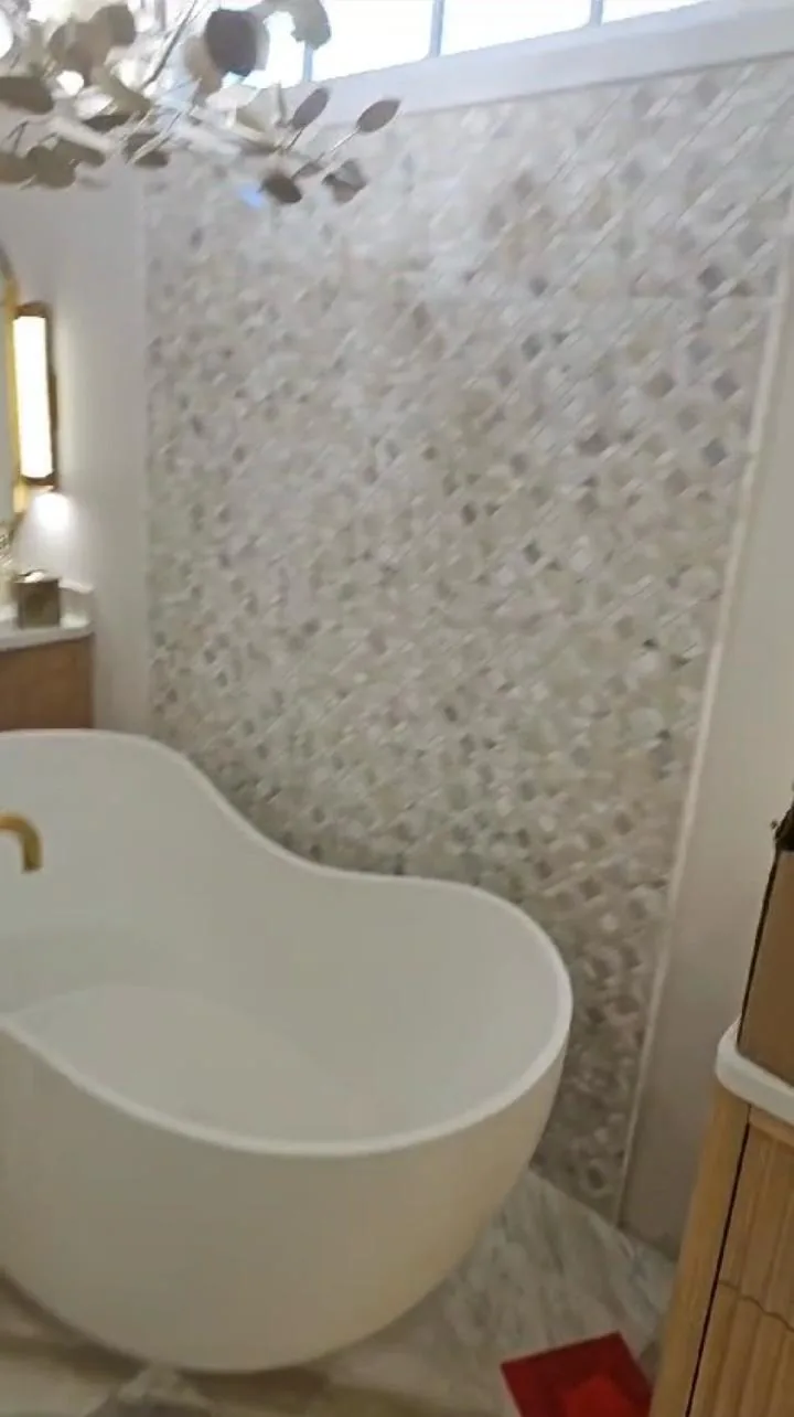 Freestanding luxury soaking tub with tiled surround