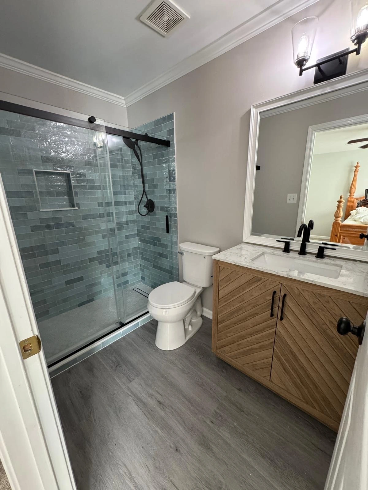 Sliding glass shower with grey tile and wood vanity — Boca Raton, FL