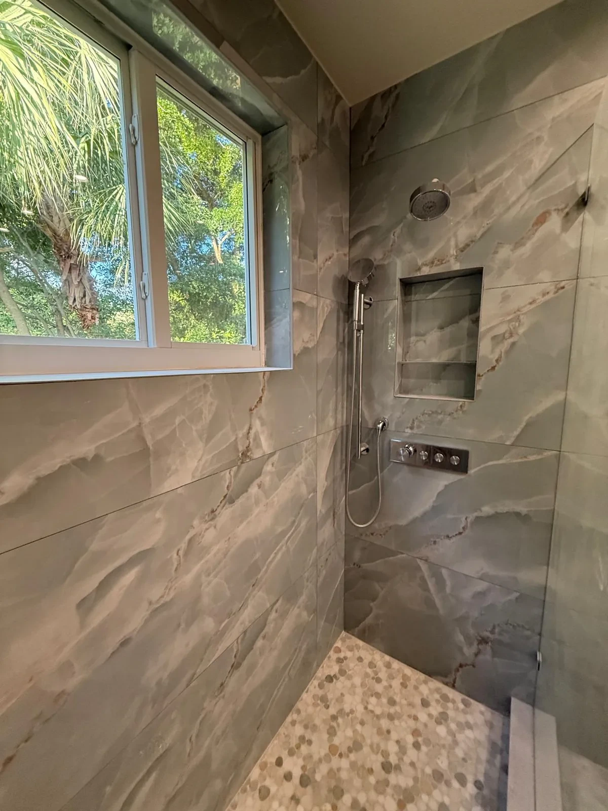 Marble shower with recessed storage niche