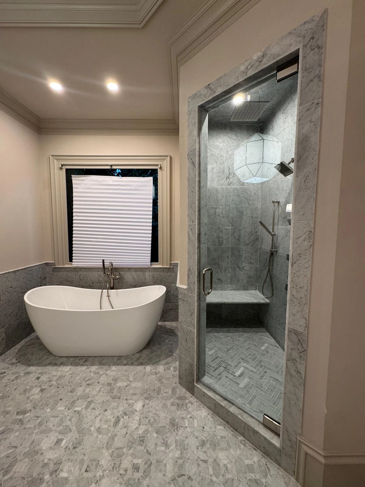Master bathroom suite with freestanding tub and marble shower