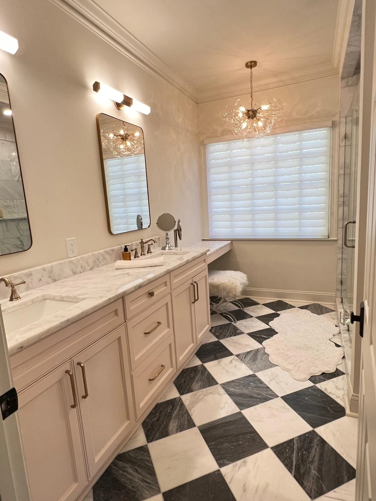 Master bathroom with double vanity, soaking tub and checkered marble floor