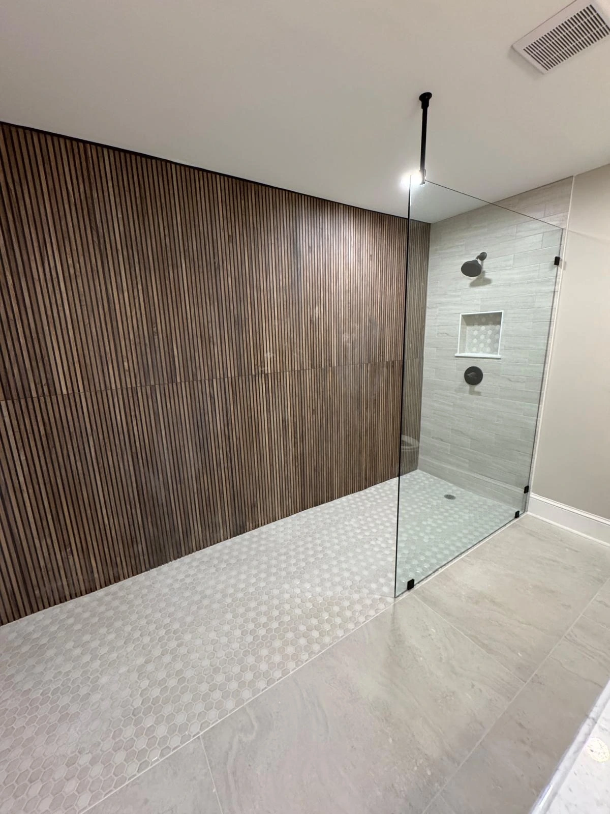 Open walk-in shower with ribbed wood-look tile and curbless entry