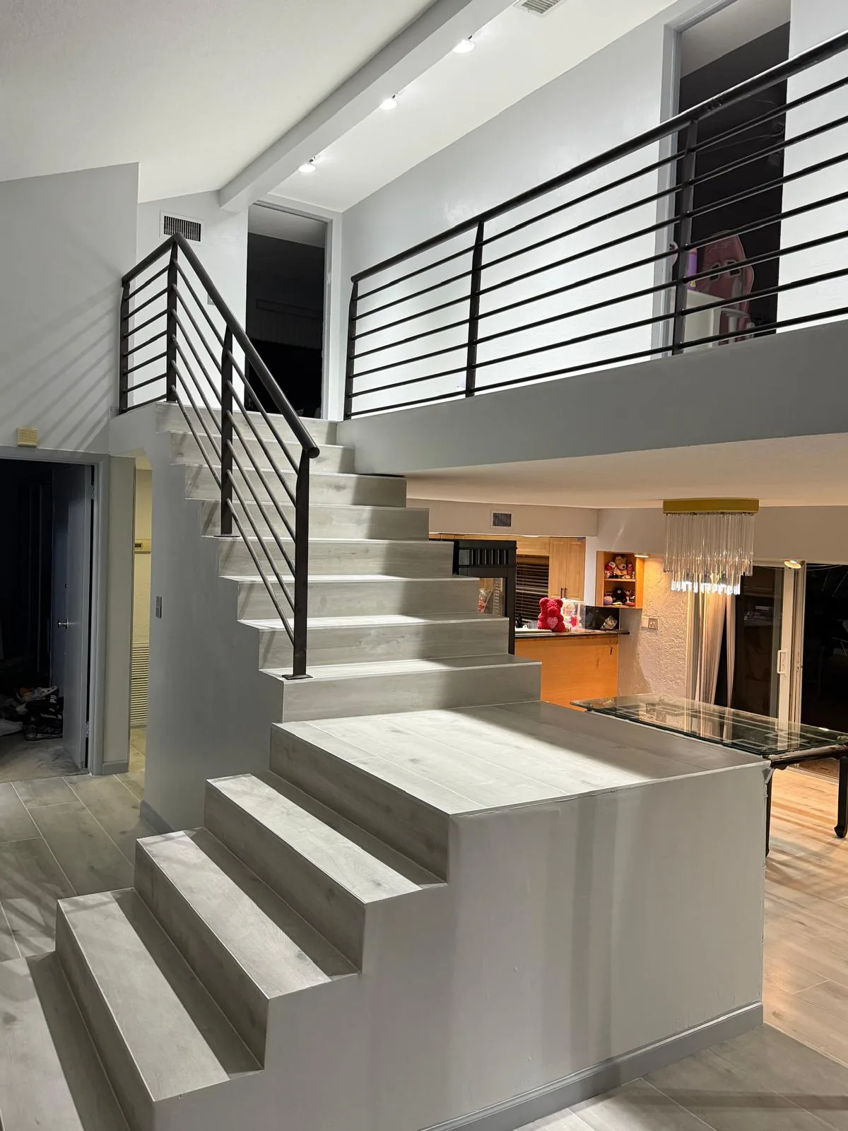 Marble-look porcelain staircase treads with black metal railing — Davie, FL