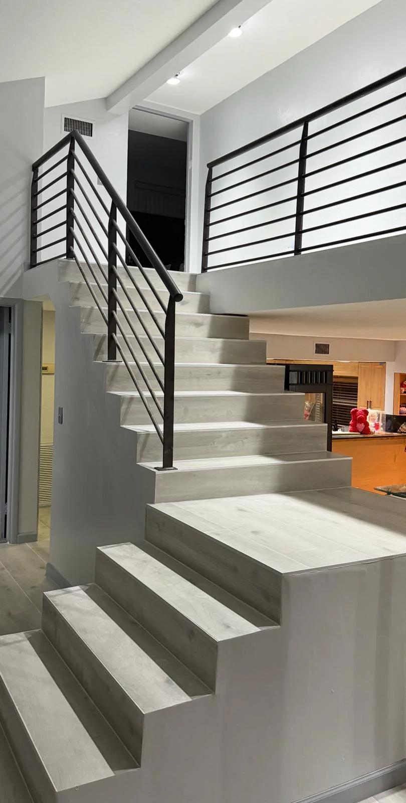 Luxury vinyl plank flooring with matching staircase treads
