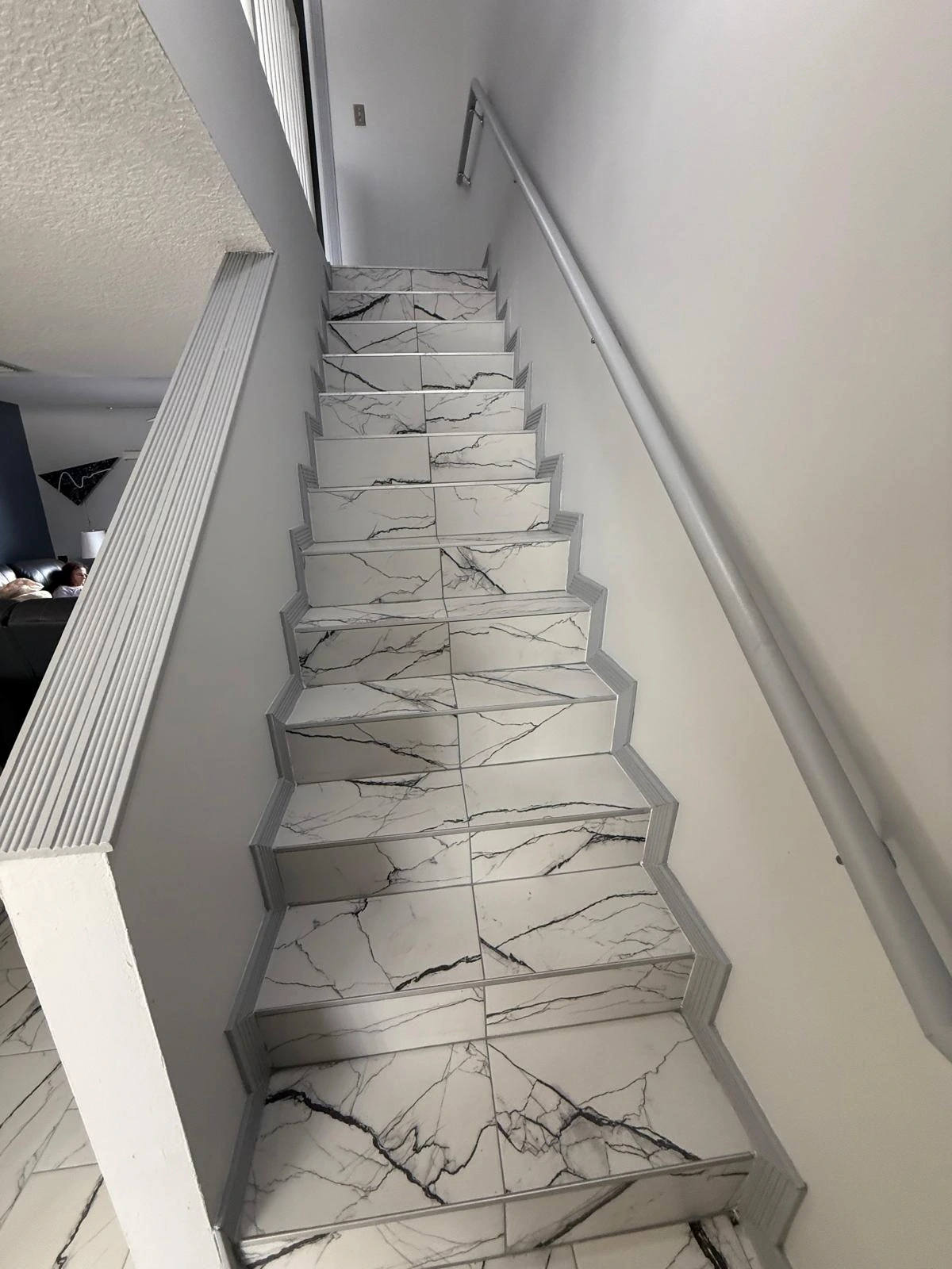 Staircase clad in marble-look porcelain tile — Davie, FL